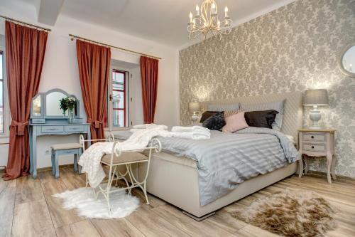 a bedroom with a bed and a desk and a mirror at Křišťanka - kouzelné apartmány in Prachatice