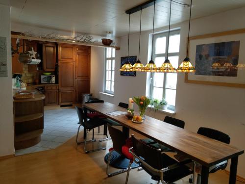 a kitchen with a long wooden table and chairs at Deutsches Eck - Bayerischer Hof in Rüdesheim am Rhein