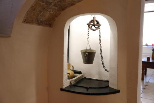 a mirror in the hallway of a house with a bucket at Can Pera Accommodation - TI in Fornalutx