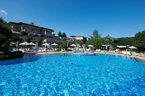 a group of people swimming in a large swimming pool at Kemer Country Hotel İstanbul in Istanbul