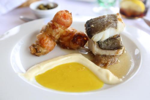 a plate of food with a sandwich and other foods at Monnaber Nou Finca Hotel & Spa in Campanet