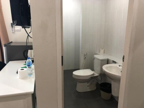 a small bathroom with a toilet and a sink at Khao Oat airport in Nai Yang Beach