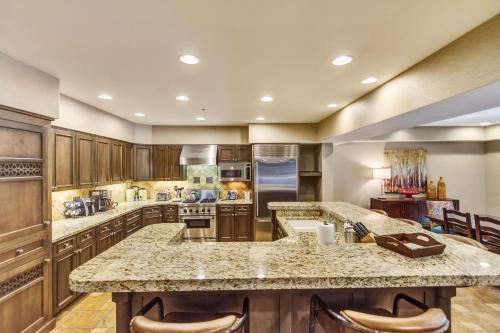 a large kitchen with wooden cabinets and a large island at The Chateaux Deer Valley in Park City