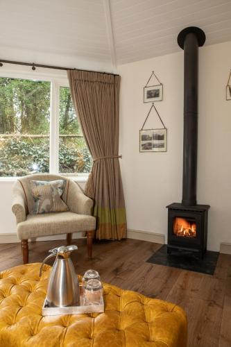 a living room with a couch and a stove at Rothay Manor Hotel in Ambleside