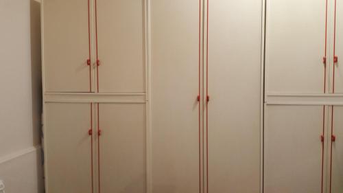 a group of white cabinets in a room at Loft Karol Taormina in Gaggi