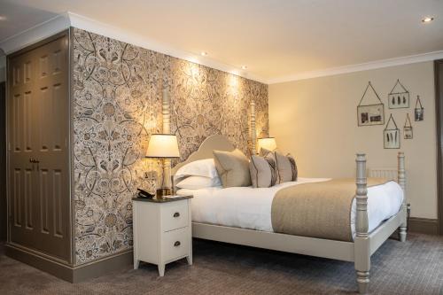 a bedroom with a large bed and a wall at Rothay Manor Hotel in Ambleside