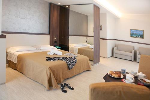 Hotel Mondial tesisinde bir odada yatak veya yataklar