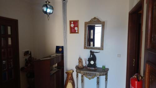 a room with a table and a mirror on the wall at Arouca à Varanda in Arouca