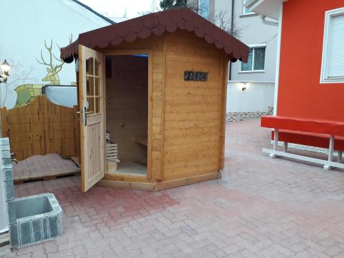 a small wooden dog house on a patio at Apartment Sagittarius in Kyustendil