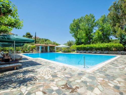 a swimming pool with a stone walkway around it at Hotel Europa Olympia in Olympia