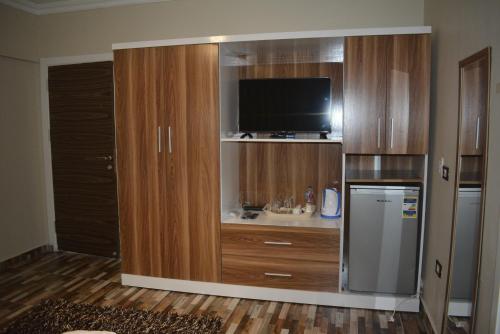 a large entertainment center with a television in a room at Pyramids Garden Motel in Cairo