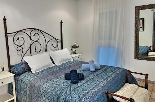 a bedroom with a bed with blue pillows and a mirror at Playa San Juan Golf in Alicante