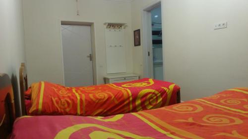 a bedroom with two beds and a mirror at Hotel Lilo near Airport in Tbilisi City