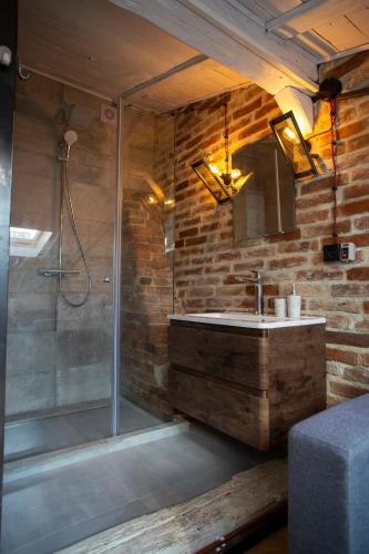 a bathroom with a glass shower and a sink at Vysoka Khata 4 in Lviv