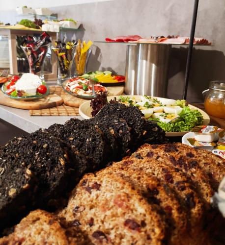 a table with many different types of food on it at Seven Hotel Bytom - Katowice in Bytom
