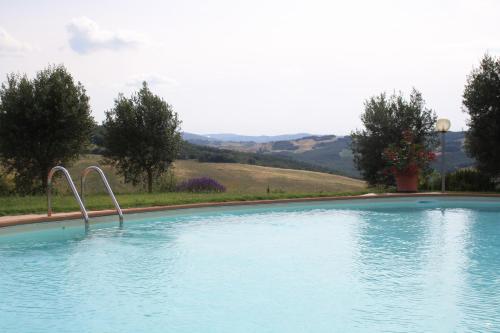 a large swimming pool with two metal bars in it at Agriturismo Materno in Radicondoli