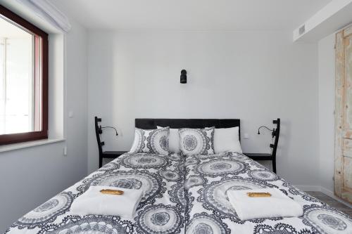 a white bedroom with a black and white bed at Ludwinowska11 Apartments in Kraków