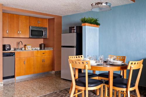 a kitchen with a table and chairs in a room at Boardwalk Resorts - Flagship in Atlantic City