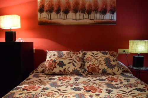 a bedroom with a bed with a pillow and two lamps at Apartamento frente a Palacio de Congresos (Fibes) in Seville