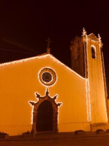 a church with christmas lights on the side of it at Casa Lilia in Monchique