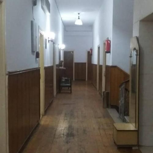 an empty hallway of a hospital with wooden stalls at De La Poste in Port Said
