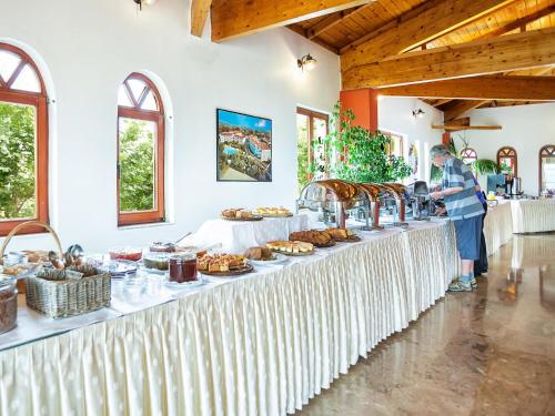 a buffet line with food on a table at Hotel Europa Olympia in Olympia