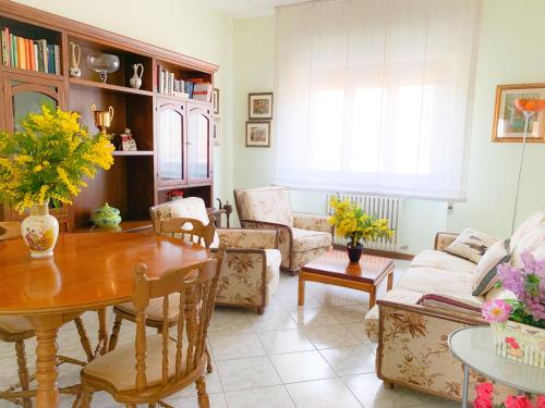 a living room with a table and a couch at Cuore di Nozzano Castello in Lucca