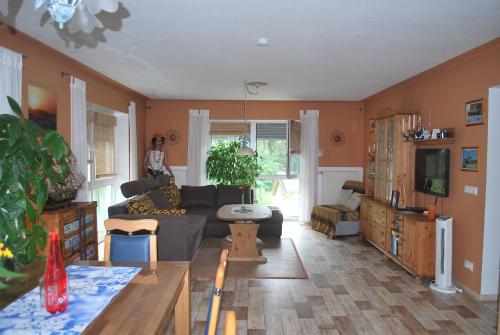 a living room with a couch and a tv at Casa Ramke in Eitorf