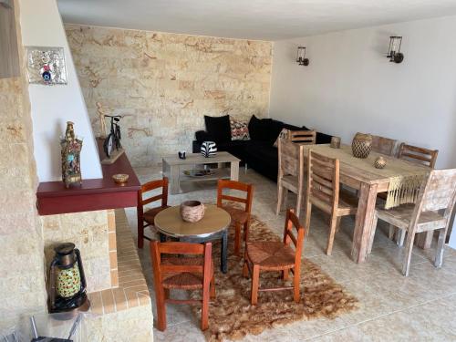 a living room with a table and chairs at Peaceful house near Airport in Pikérmion