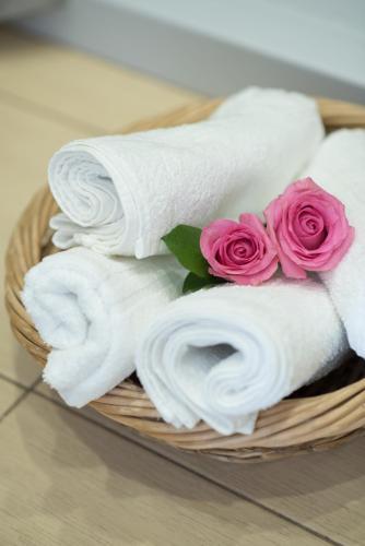a basket filled with towels and pink roses at Elounda Dream House in Elounda