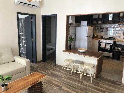 a kitchen and living room with a counter and stools at Casa Mia in Monchique