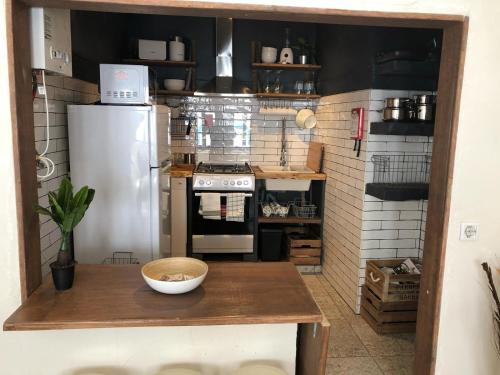 a small kitchen with a refrigerator and a table at Casa Mia in Monchique