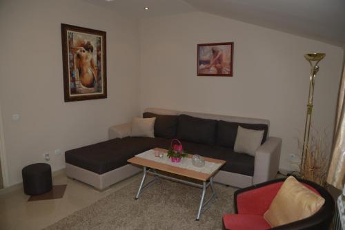 a living room with a couch and a table at Apartments Skadarlija in Belgrade