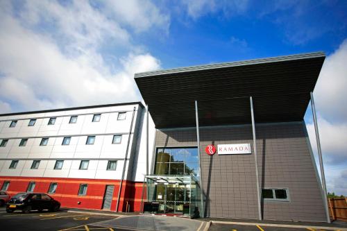 a building with a car parked in front of it at Ramada Birmingham Oldbury M5 J2 in Oldbury