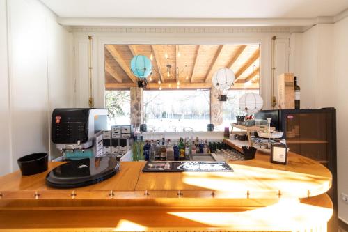 a kitchen with a counter with a sewing machine on it at Hotel rural Finca Vivaldi Nature & Spa in San Miguel de las Dueñas