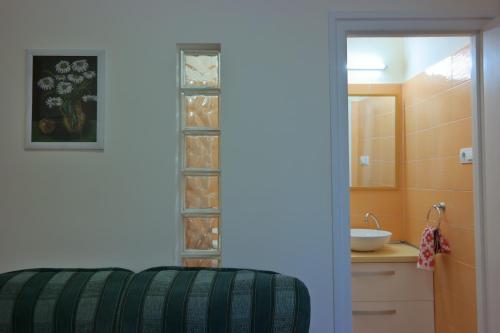a bathroom with a sink and a toilet in a room at Révay Apartment in Szeged