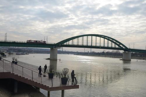 a bridge over a river with people walking on it at Apartments Skadarlija in Belgrade