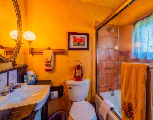 a bathroom with a sink and a toilet and a tub at Buckeye's Cabin in Leadville
