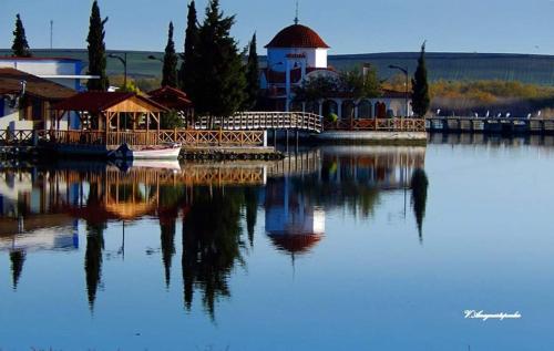 a large body of water with a house and a building at Tzivaeri in Likodhrómion
