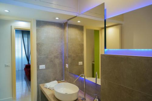 uma casa de banho com um lavatório e um chuveiro com um espelho. em Re di Roma bright home em Roma