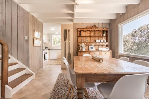 a kitchen with a dining room table and chairs at The Oar House in Metung