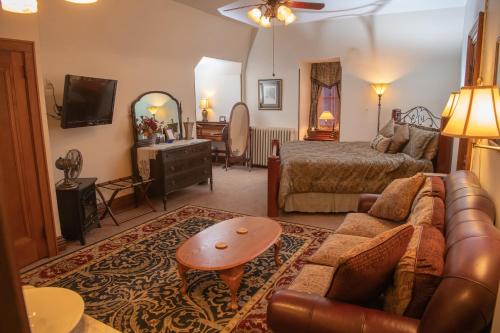 a living room with a couch and a bed at Spencer House Bed & Breakfast in Erie