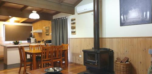 a kitchen and dining room with a stove in a room at Day Dream Cottage in Halls Gap