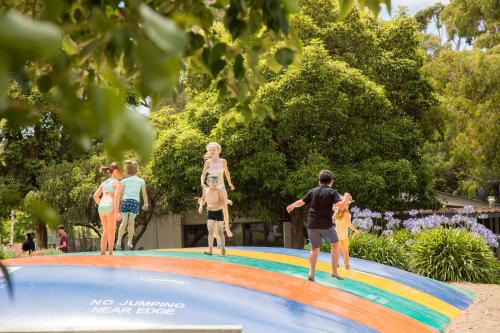 a group of people standing on top of a swimming pool at Blue Lake Holiday Park in Mount Gambier