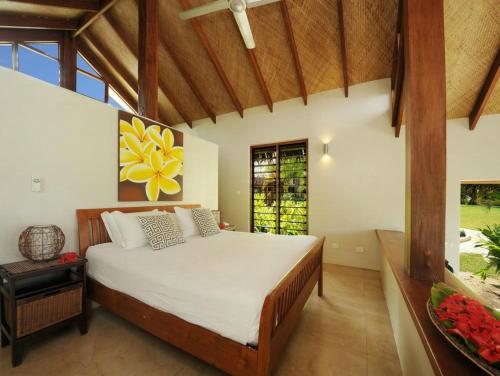 a bedroom with a large bed in a room at MG Cocomo Resort Vanuatu in Port Vila