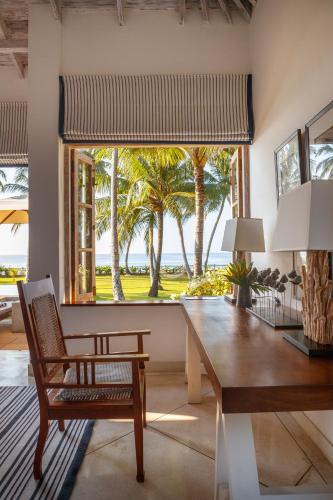 a dining room with a table and a view of the ocean at Habaraduwa House in Habaraduwa