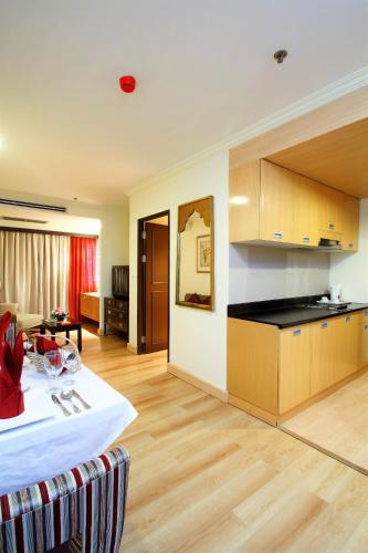 a kitchen and a living room with a table at Princeton Bangkok in Bangkok
