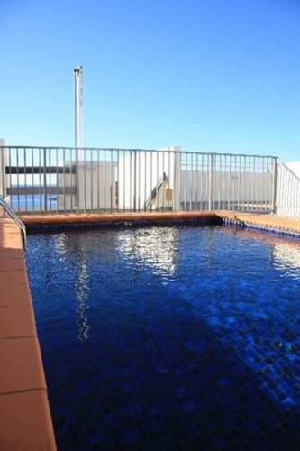 a large pool of blue water in front of a building at manlybeachonline.com713 At The Beach in Sydney