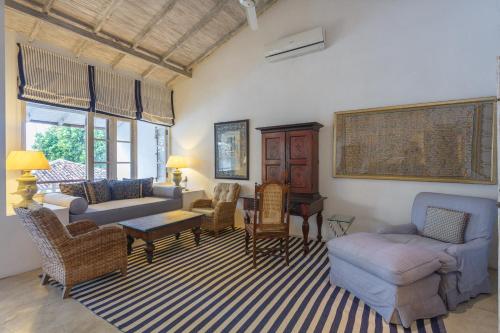 a living room with a couch and chairs and a table at Habaraduwa House in Habaraduwa