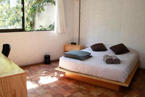 Ένα ή περισσότερα κρεβάτια σε δωμάτιο στο Coyoacan City Lofts
